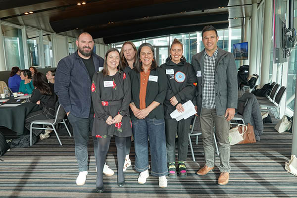 The panel members standing with Tahlia and Shawana
