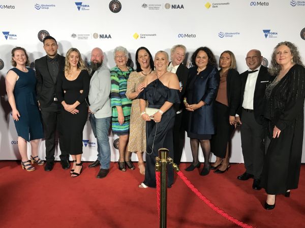 Poche team at NAIDOC awards night standing in a line on the red carpet